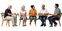 five people sitting around a table engaging in conversation discussing ideas